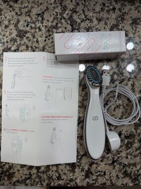 Nuskin ageLOC Boost Activating Serum Skin Treatment Device and a bottle of serum
